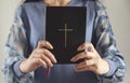 Young prayer woman holding Bible