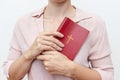 Young praying christian woman`s hands holding holy bible with a cross on a cover Royalty Free Stock Photo