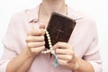 Young praying christian woman`s hands with a rosary and holy bible Royalty Free Stock Photo