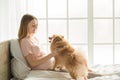 Young preganant woman expecting a baby relaxing on bed indoors Royalty Free Stock Photo