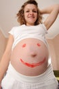 Young pregnanant with painted smile sign Royalty Free Stock Photo