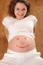 Young pregnanant with painted smile sign Royalty Free Stock Photo