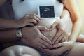Young Pregnant Asian Woman Holds Her Hands on Her Swollen Belly, Love Concept. Royalty Free Stock Photo