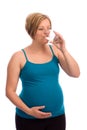 Young pregnant Caucasian woman drinking water
