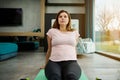 Young pregnant Caucasian woman exercising on a fitness mat during pregnancy. Active sporty future mum, in anticipation of a baby Royalty Free Stock Photo