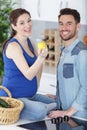 young pregnant couple cooking food fruit lemon juice at kitchen Royalty Free Stock Photo