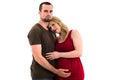 Young pregnant couple in love expecting child, studio portrait Royalty Free Stock Photo