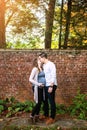 Pregnant couple kissing in front of brick wall Royalty Free Stock Photo