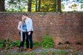 Pregnant couple kissing in front of brick wall Royalty Free Stock Photo