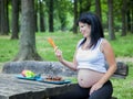 Young pregnant girl choosing food for her meal Royalty Free Stock Photo