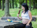 Young pregnant girl choosing food for her meal Royalty Free Stock Photo