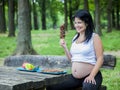 Young pregnant girl choosing food for her meal Royalty Free Stock Photo