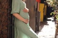 Young pregnant girl strokes her belly. Girl expecting a baby. Pregnant woman touching her belly Royalty Free Stock Photo