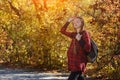 Young pregnant woman in the autumn forest. With closed eyes, enjoys nature. Sunny day Royalty Free Stock Photo