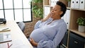 Young pregnant woman business worker tired sitting on table yawning at office Royalty Free Stock Photo