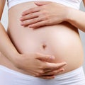 Young pregnant woman caress belly.