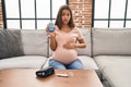 Young pregnant woman checking blood sugar clueless and confused expression Royalty Free Stock Photo