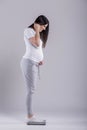 Young pregnant woman checking weight Royalty Free Stock Photo