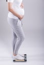 Young pregnant woman checking weight Royalty Free Stock Photo