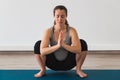 Young pregnant woman doing prenatal yoga pose with namaste hands Royalty Free Stock Photo