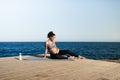 Young pregnant woman doing yoga outdoor - Sport exercises and maternity concept for healthy lifestyle - Focus on face Royalty Free Stock Photo