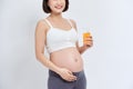 Young pregnant woman drinking orange juice with pleasure Royalty Free Stock Photo