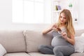 Young pregnant woman eating chocolate bar Royalty Free Stock Photo