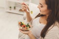 Young pregnant woman eating fresh green salad Royalty Free Stock Photo