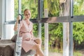 Young pregnant woman enjoys cleaning her house. Easy cleaning with a wireless vacuum cleaner. Pregnant woman cleaning Royalty Free Stock Photo