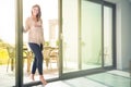 Young pregnant woman entering house from garden Royalty Free Stock Photo