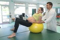 Young pregnant woman exercising at antenatal class