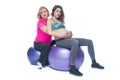 Young pregnant woman exercising with physiotherapist in birthing school. Doctor`s help conceptat in antenatal class Royalty Free Stock Photo