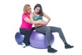 Young pregnant woman exercising with physiotherapist in birthing school. Doctor`s help conceptat in antenatal class Royalty Free Stock Photo