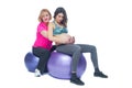 Young pregnant woman exercising with physiotherapist in birthing school. Doctor`s help conceptat in antenatal class Royalty Free Stock Photo