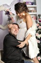 Young pregnant woman and happy father decorating Christmas tree