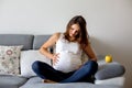 Young pregnant woman, having painful contraction, starting labor Royalty Free Stock Photo