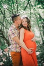 Young pregnant woman with her husband holding hands on her belly Royalty Free Stock Photo