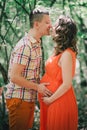 Young pregnant woman with her husband holding hands on her belly Royalty Free Stock Photo