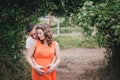 Young pregnant woman with her husband holding hands on her belly Royalty Free Stock Photo