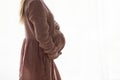 Young pregnant woman holding in arms big belly. Royalty Free Stock Photo