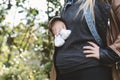 Young pregnant woman holding baby booties on her abdomen. Royalty Free Stock Photo