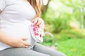 Young pregnant woman holding baby shoes to her belly Royalty Free Stock Photo