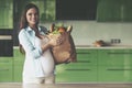 Young Pregnant Woman Holding Bag with Fruits. Royalty Free Stock Photo