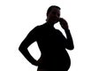 Young pregnant woman holding cell phone in her hand speaking with someone. Royalty Free Stock Photo