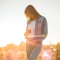 Young Pregnant Woman holding ultrasound photo at Sunset and Embracing her Belly. 4 Month Pregnancy. Maternity Concept. Toned Photo Royalty Free Stock Photo