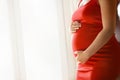 Young pregnant woman holds her hands on her big belly. Love concept Royalty Free Stock Photo