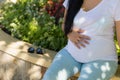 A young pregnant woman holds her hands on her tummy and feels the tremors of her baby Royalty Free Stock Photo