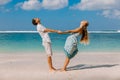 Young pregnant woman with husband relaxing at paradise beach. Happy couple in tropics Royalty Free Stock Photo