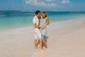 Young pregnant woman with husband relaxing at paradise beach. Happy couple in tropics Royalty Free Stock Photo