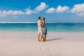 Young pregnant woman with husband relaxing at paradise beach. Happy couple in tropics Royalty Free Stock Photo